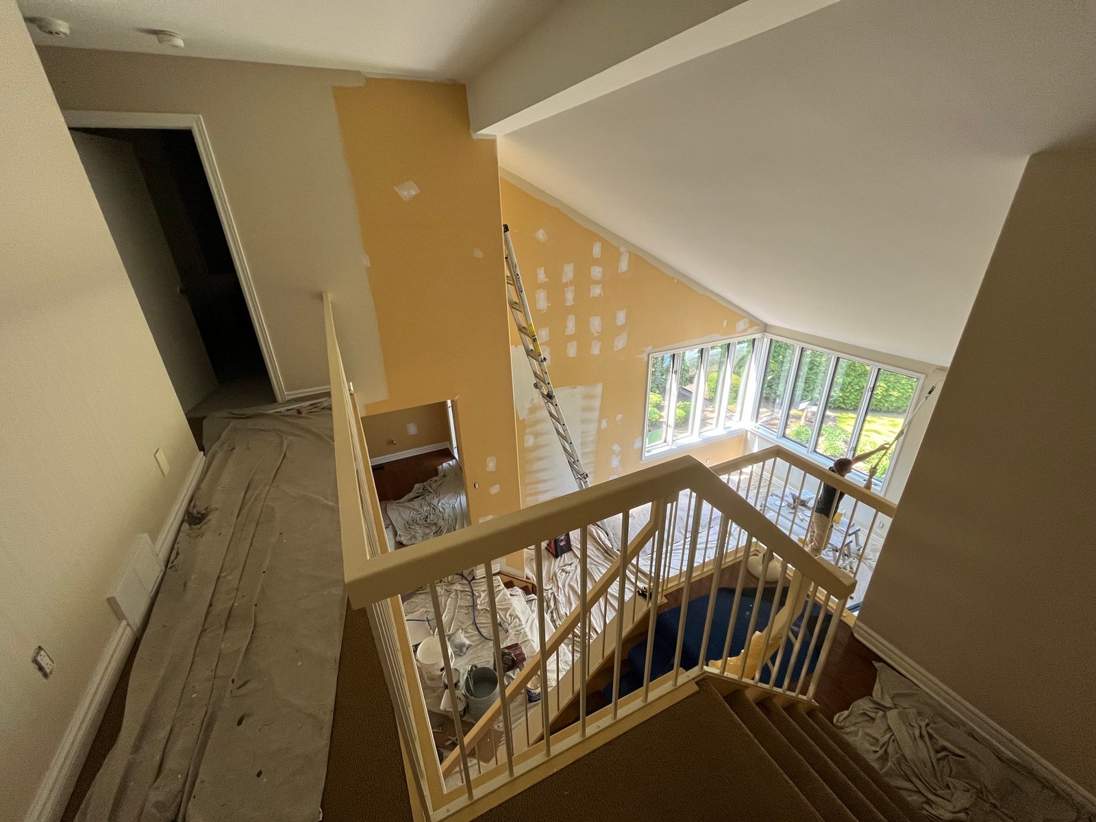 Stairwell repaint — warm accent walls in progress